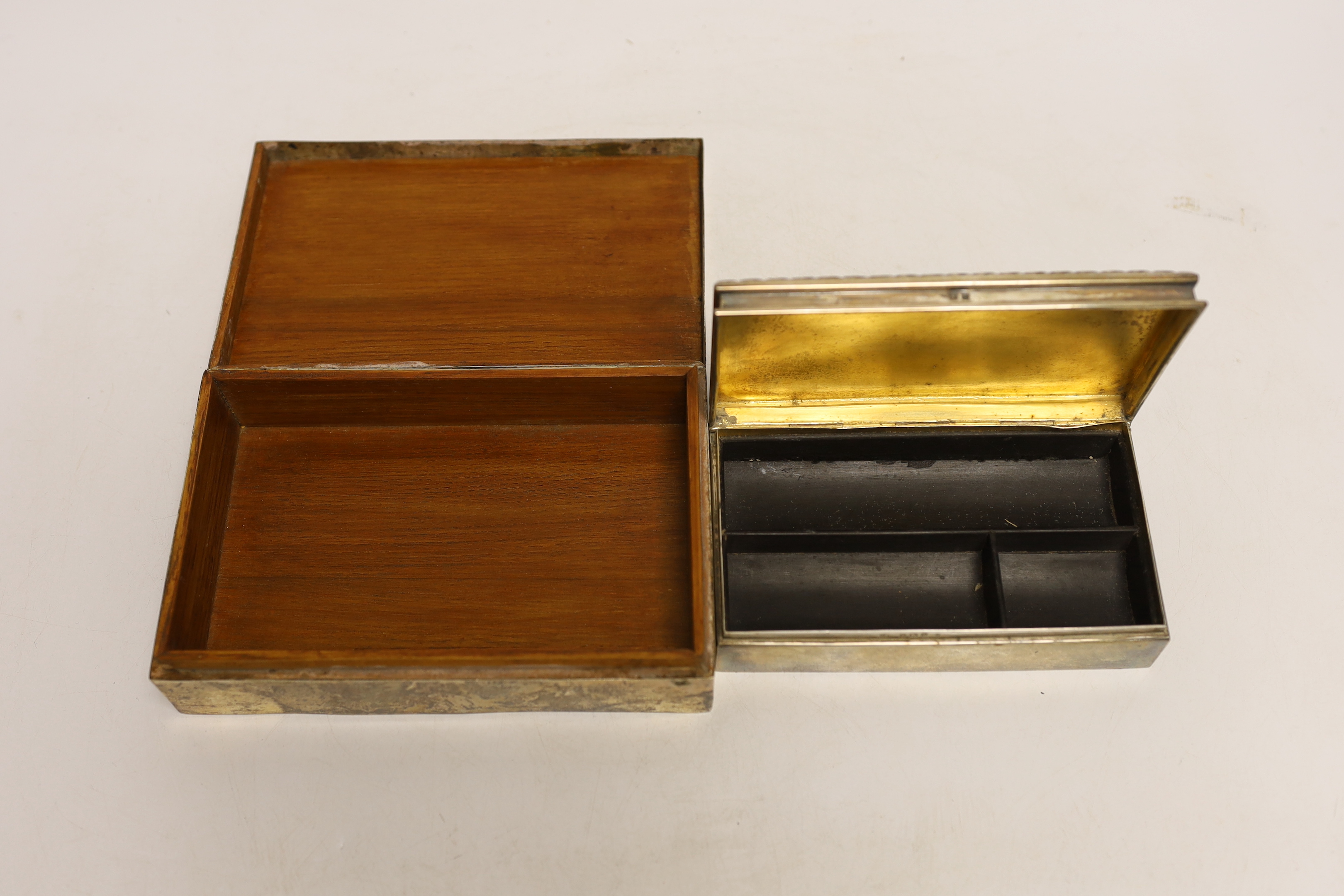 An Edwardian silver mounted rectangular cigarette box, by Synyer & Beddoes, Birmingham, 1908, 14cm, together with a larger Persian white metal mounted cigarette box.